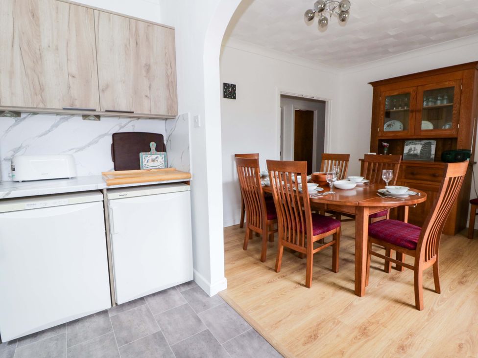 A dining room with a table and chairs at No.1 Vanderhoof Way Saundersfoot
