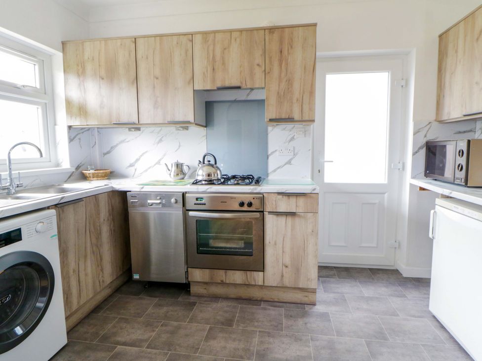 A kitchen with appliances and cabinets at No.1 Vanderhoof Way Saundersfoot