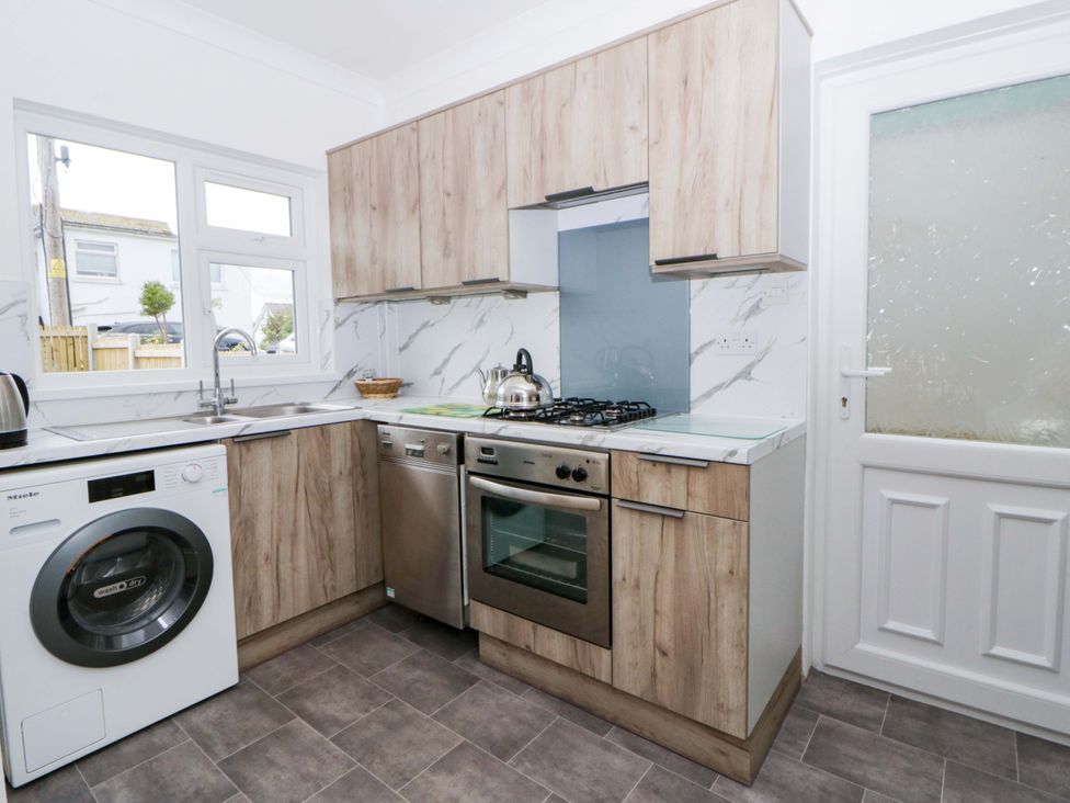 A kitchen with appliances at No.1 Vanderhoof Way Saundersfoot
