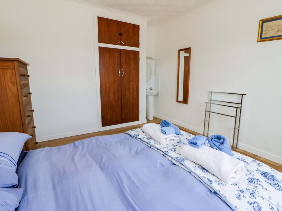 A bedroom with a bed and towels arranged on it at No.1 Vanderhoof Way in Saundersfoot