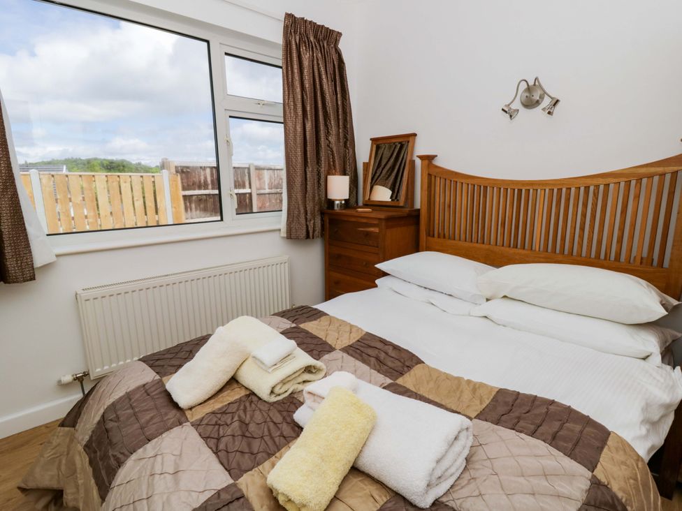 A bedroom with a bed and dresser at No.1 Vanderhoof Way Saundersfoot