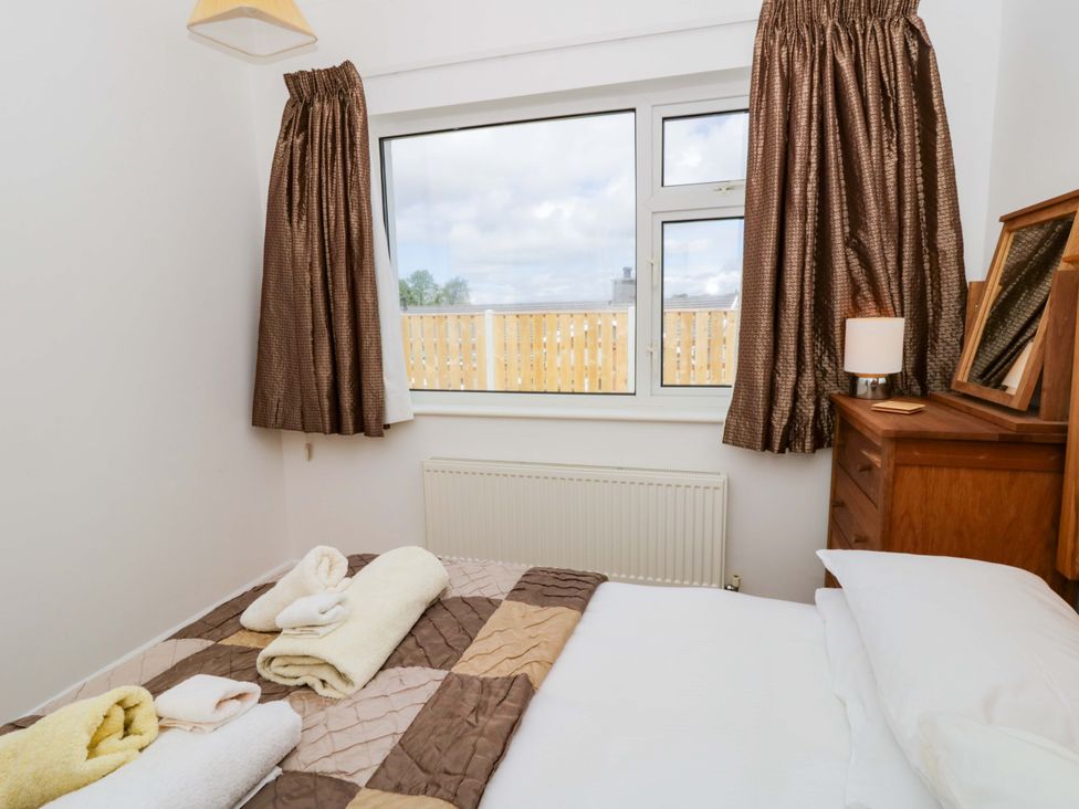 A bedroom with a bed and window at No.1 Vanderhoof Way Saundersfoot