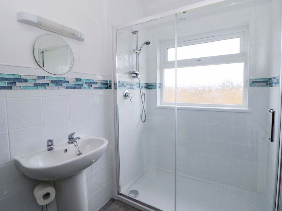 A bathroom with a shower and sink at No.1 Vanderhoof Way in Saundersfoot