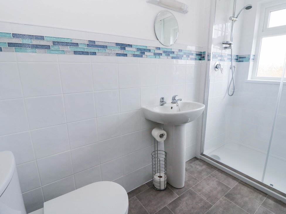 A bathroom with a sink and shower at No.1 Vanderhoof Way Saundersfoot