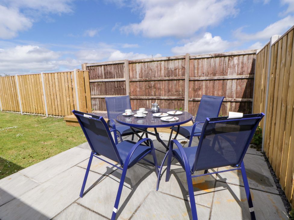 A garden with a table and chairs set at No.1 Vanderhoof Way Saundersfoot