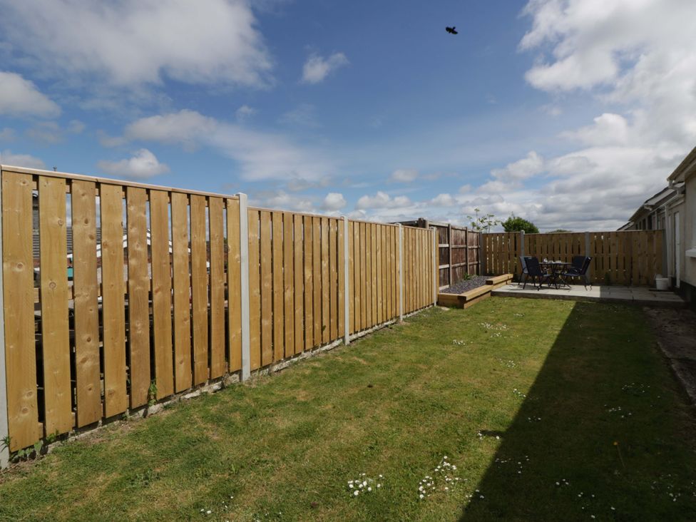 A garden area with fencing and patio furniture at No.1 Vanderhoof Way Saundersfoot