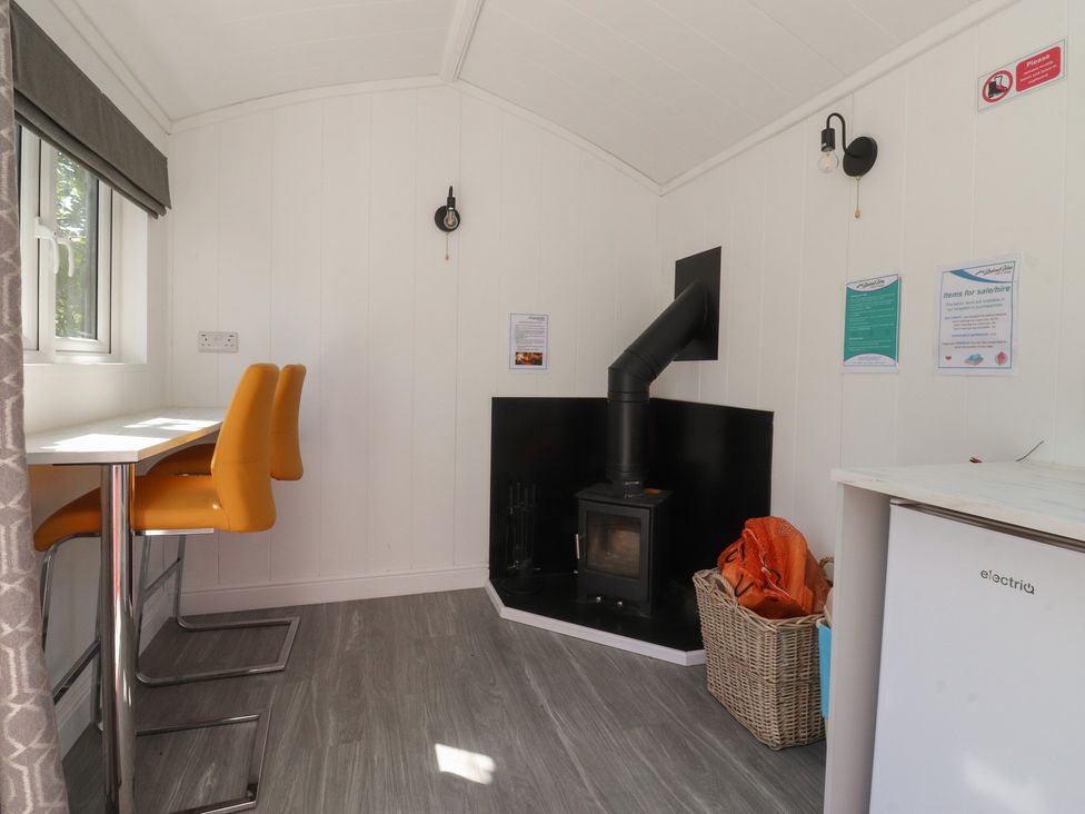 A dining area with table and chairs at Butterfly Hut 1 Forton near Garstang