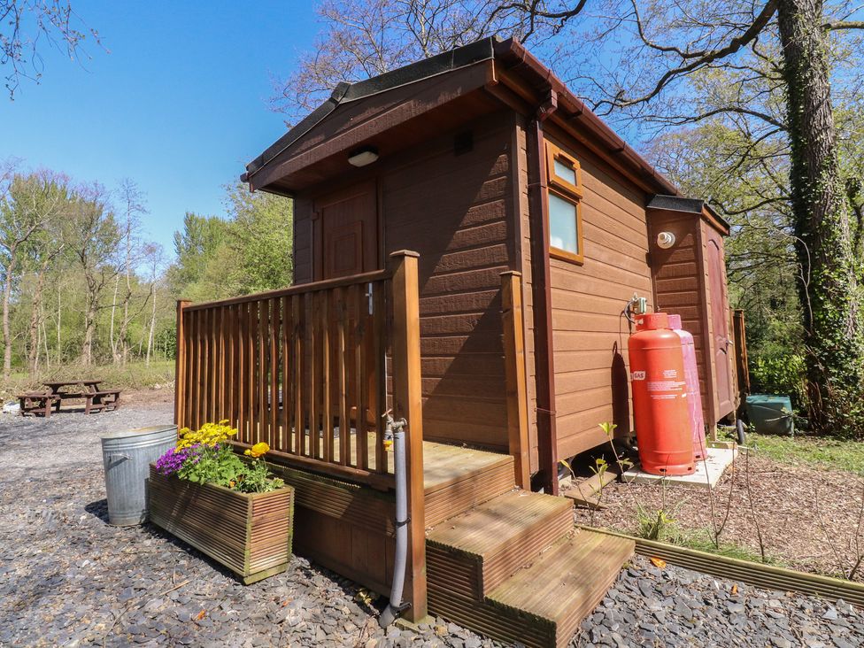 A cabin with steps and a planter at Butterfly Hut 1 Forton near Garstang