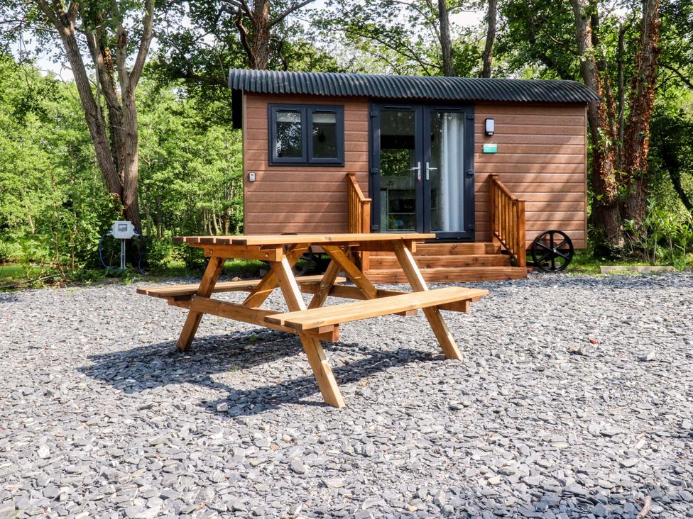 A cabin with a bench in the outdoor area at Shepherds Hut 2 