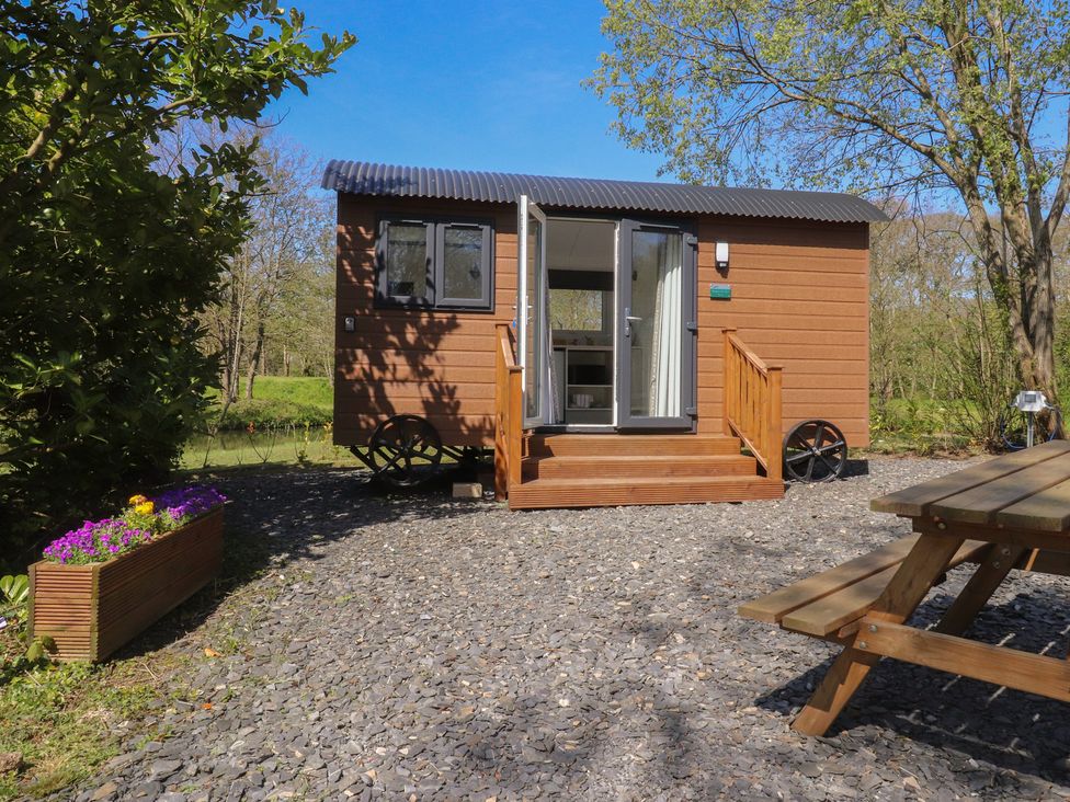 A tiny house with steps and outdoor seating at Butterfly Hut 2 Forton near Garstang