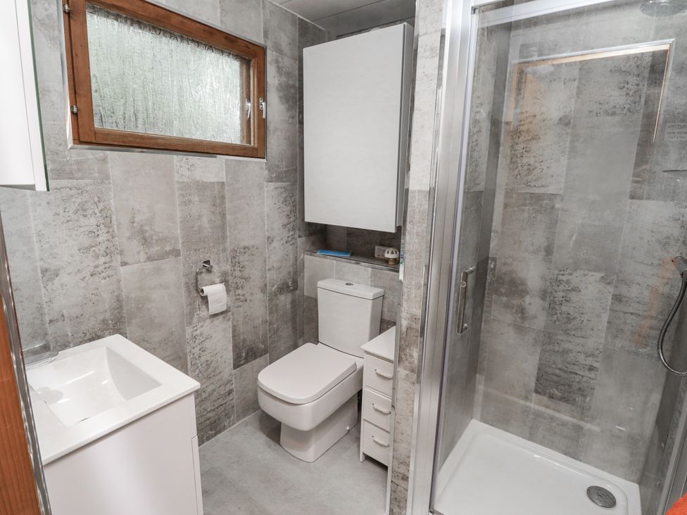 A bathroom with toilet and shower at Farnes Lodge Longframlington