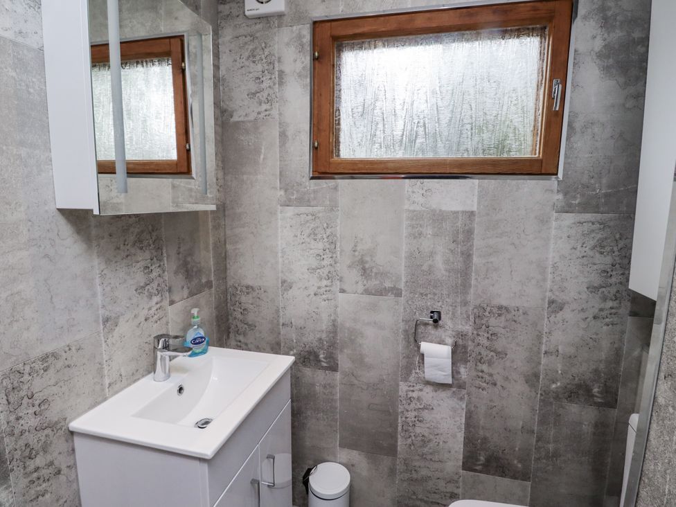 A bathroom with a sink and toilet at Farnes Lodge in Longframlington