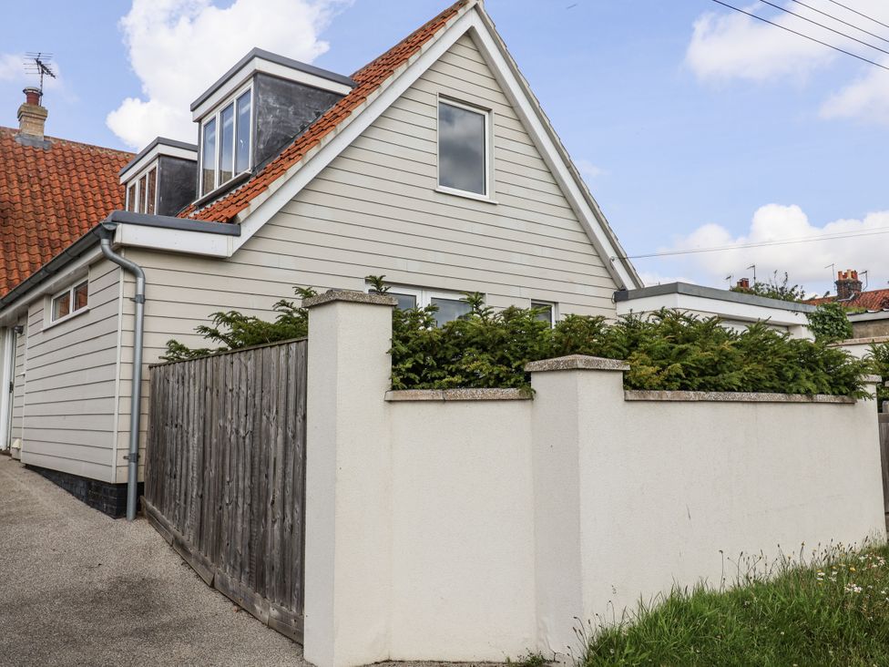 A house with a garden and fencing at The Annex next to St Johns Southwold