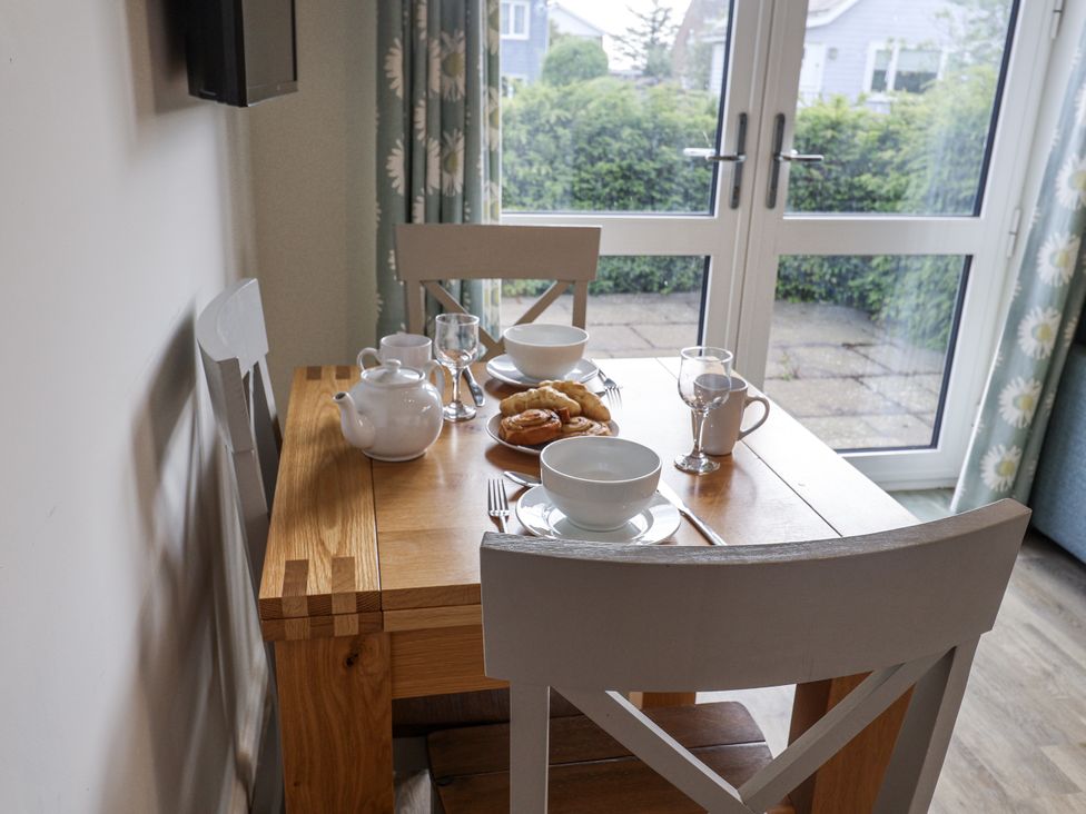 A dining room with a table set for breakfast at The Annex next to St Johns Southwold