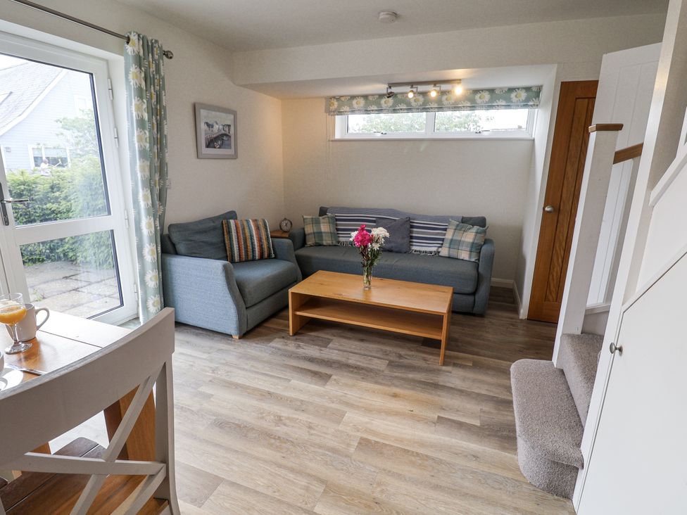 A living room with a sofa and coffee table at The Annex next to St Johns Southwold