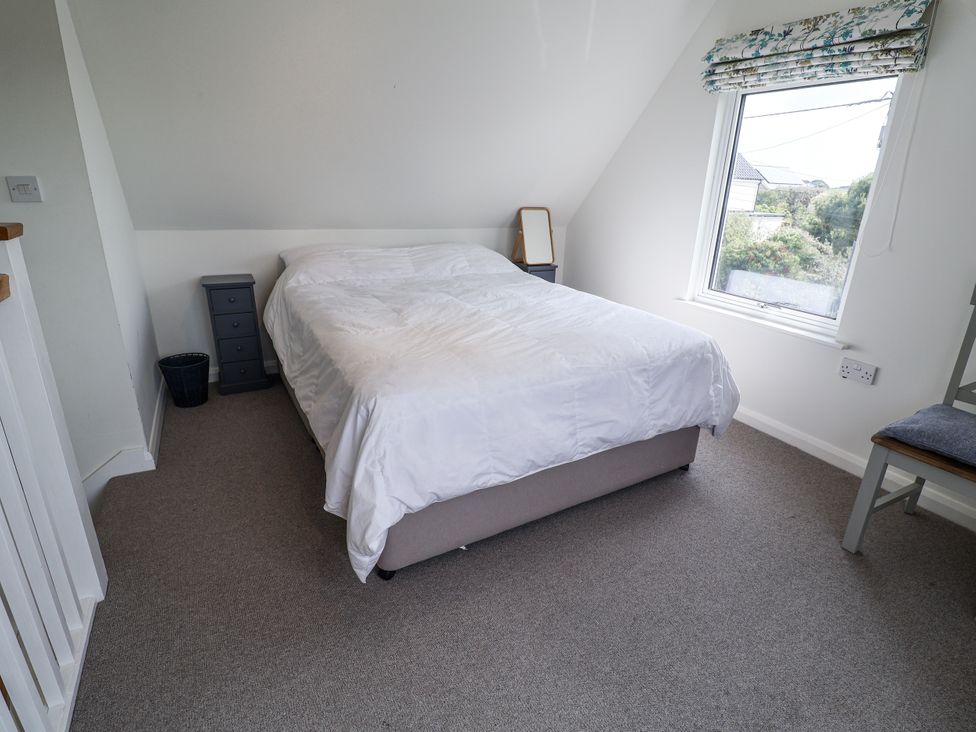 A bedroom with a bed and nightstand at The Annex next to St Johns in Southwold