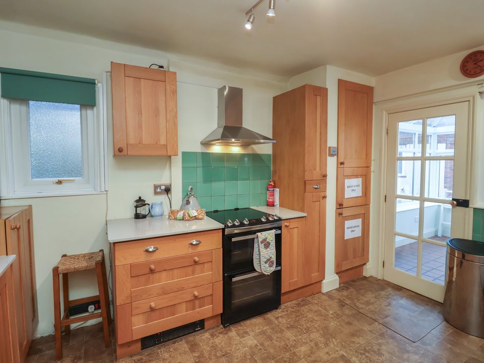 A kitchen with cabinets and an oven at The Anchorage in 