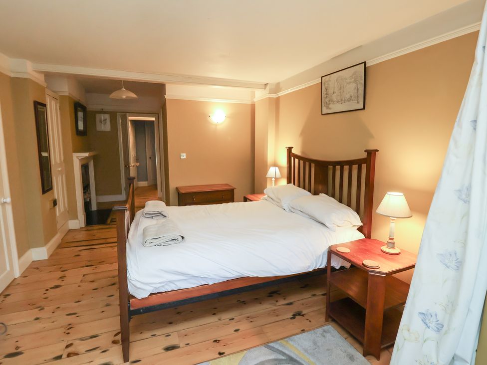 A bedroom with a bed and nightstand at The Anchorage in 