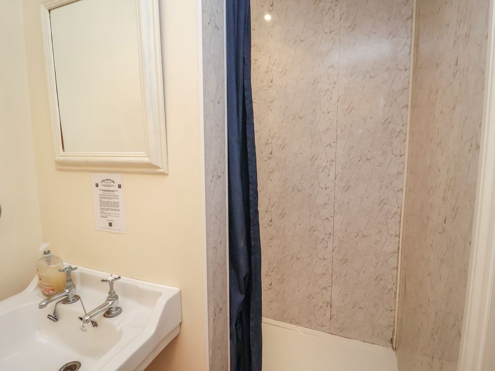 A bathroom with a sink and a shower at The Anchorage