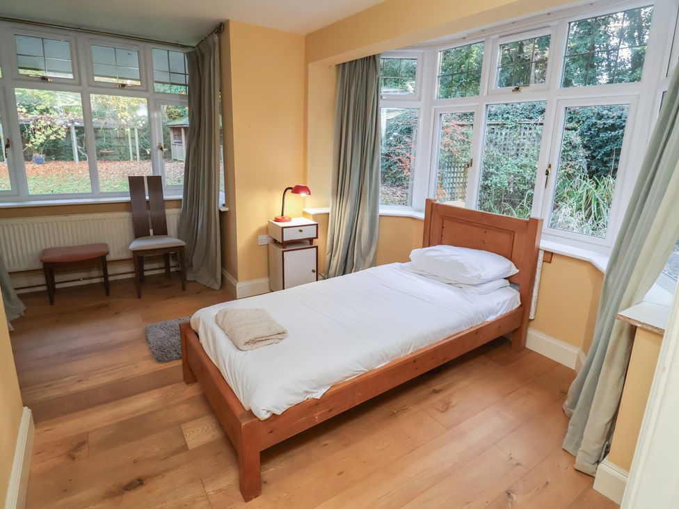 A bedroom with a bed and lamp at The Anchorage in 