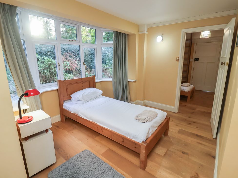 A bedroom with a bed and lamp in a house at The Anchorage