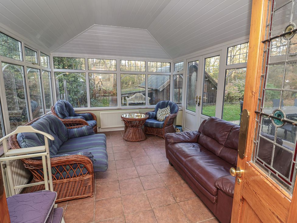 A conservatory with seating and a coffee table at The Anchorage