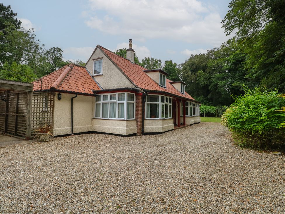 A house with a driveway and garden at The Anchorage in Hoveton & Wroxham