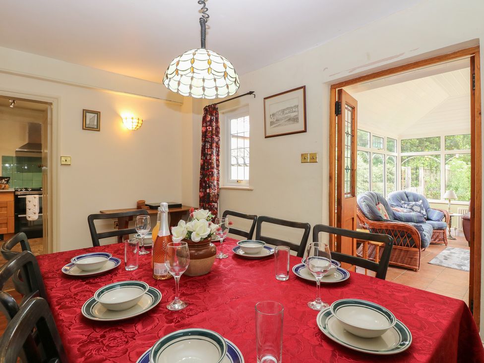A dining room with a table set for a meal at The Anchorage in Hoveton & Wroxham