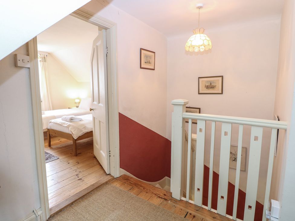A hallway with a staircase and a door at The Anchorage in Hoveton & Wroxham