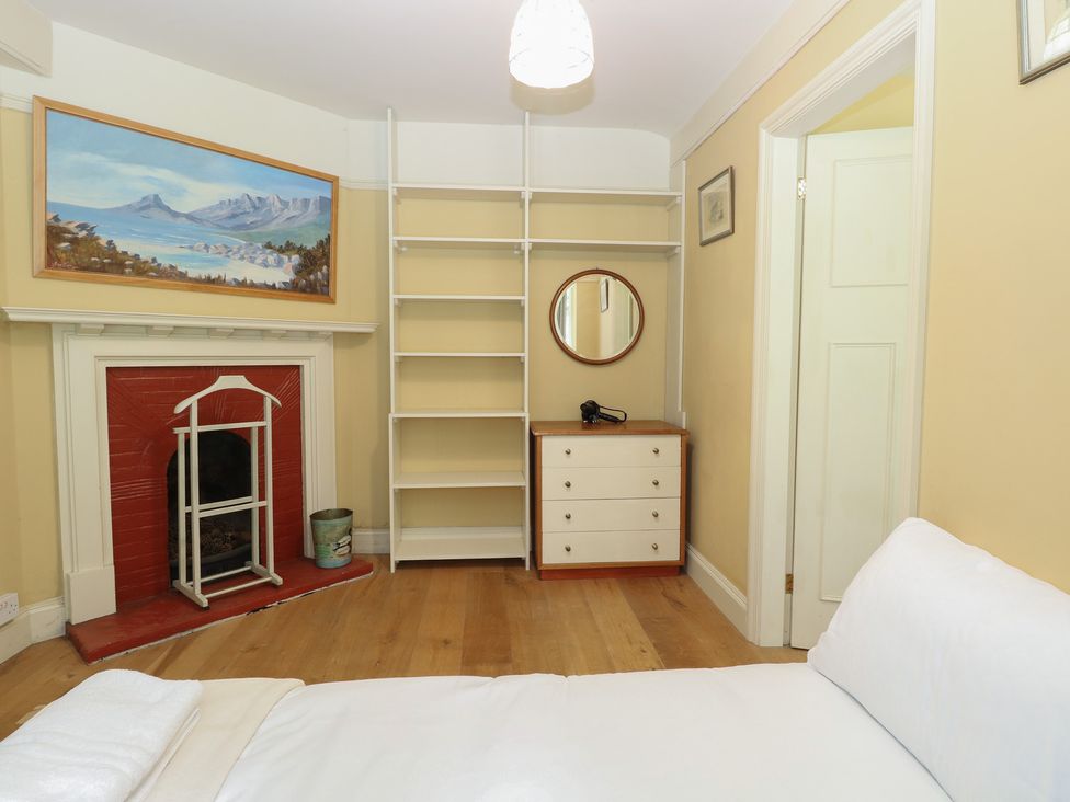 A bedroom with a bed and fireplace at The Anchorage in Hoveton & Wroxham