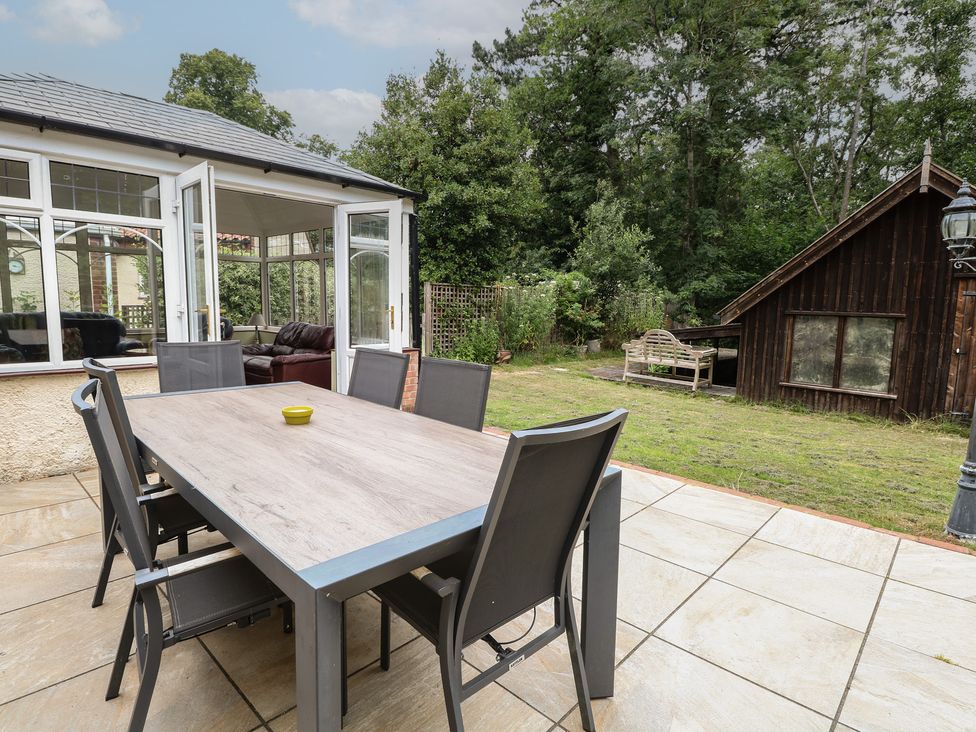 A garden with a table and chairs at The Anchorage in Hoveton & Wroxham