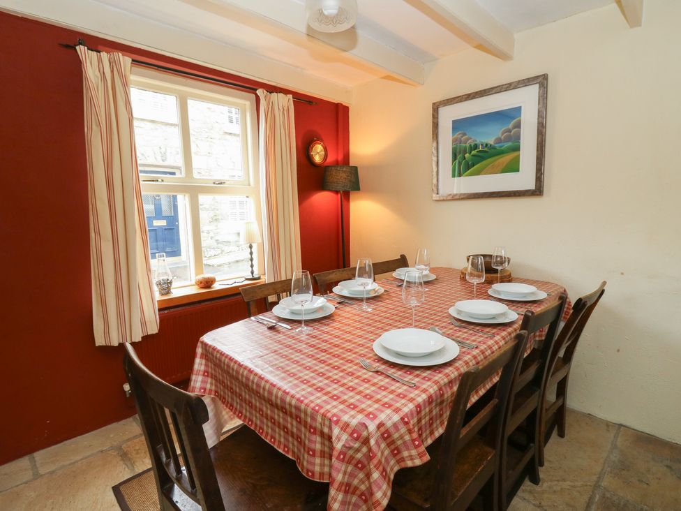 A dining room with a table set for dinner at St John's House in Newport, Pembrokeshire