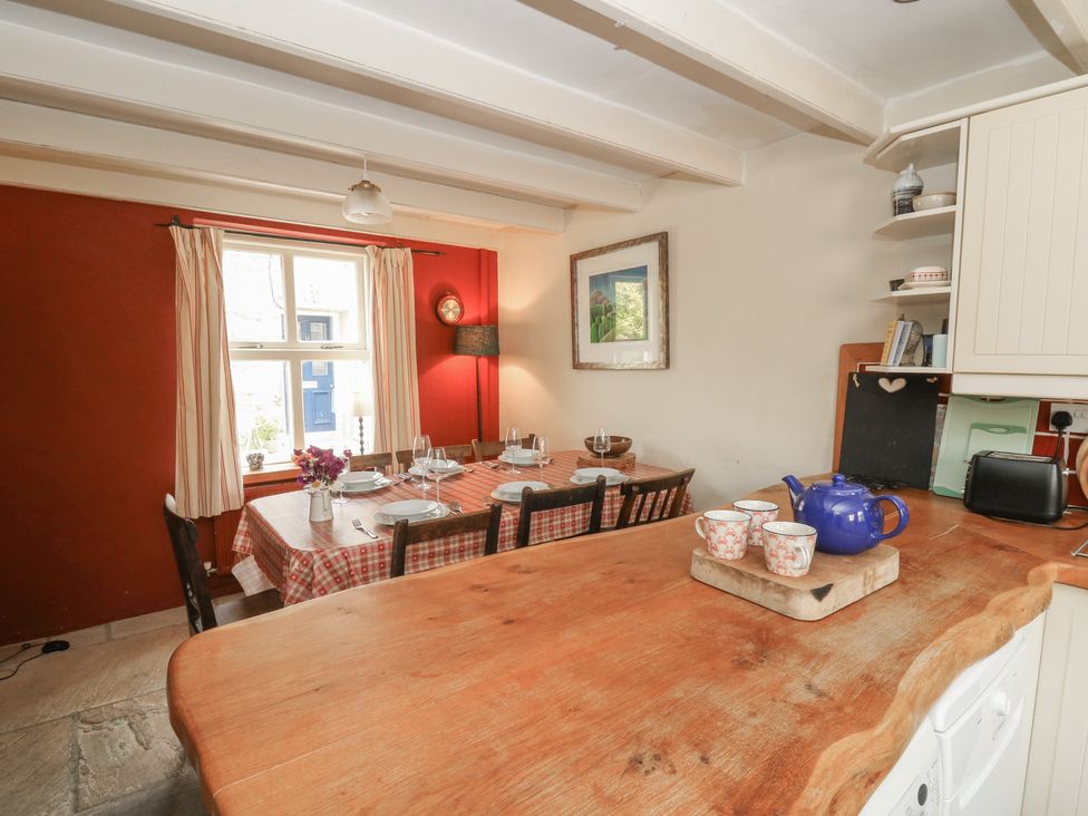 A kitchen with a dining table and teapot at St John's House Newport, Pembrokeshire
