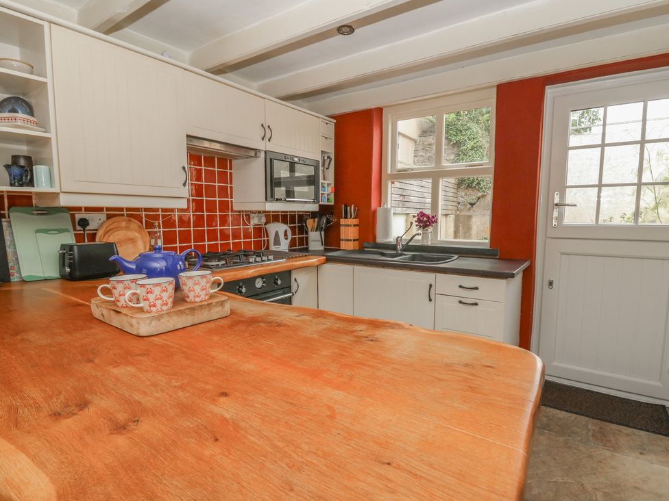 A kitchen with a sink and cooking appliances at St John's House in Newport, Pembrokeshire