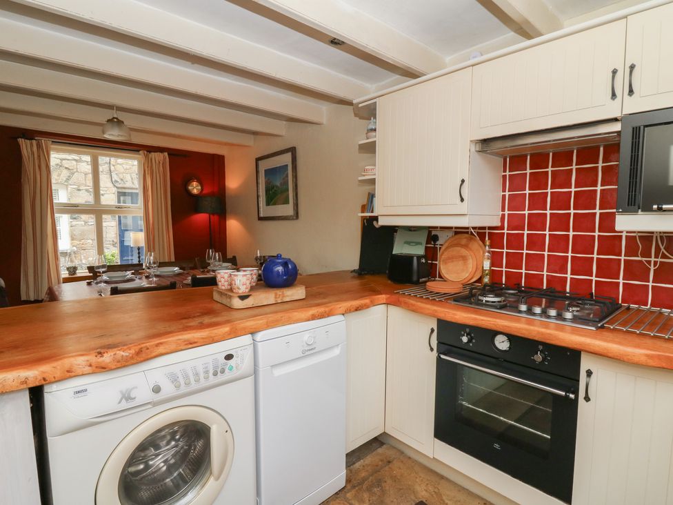 A kitchen with a washing machine and dishwasher at St John's House in Newport, Pembrokeshire