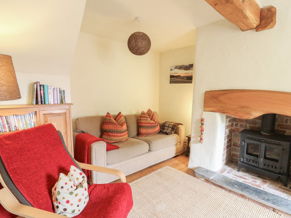 A living room with a sofa and armchair at St John's House in Newport, Pembrokeshire