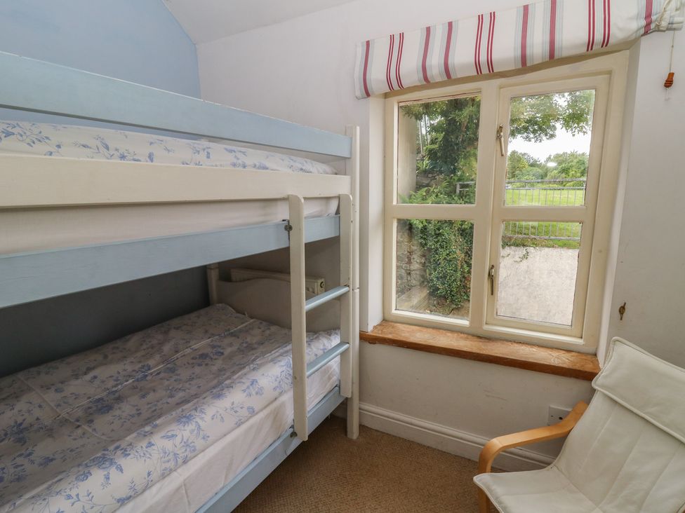 A bedroom with a bunk bed and a window at St John's House Newport, Pembrokeshire