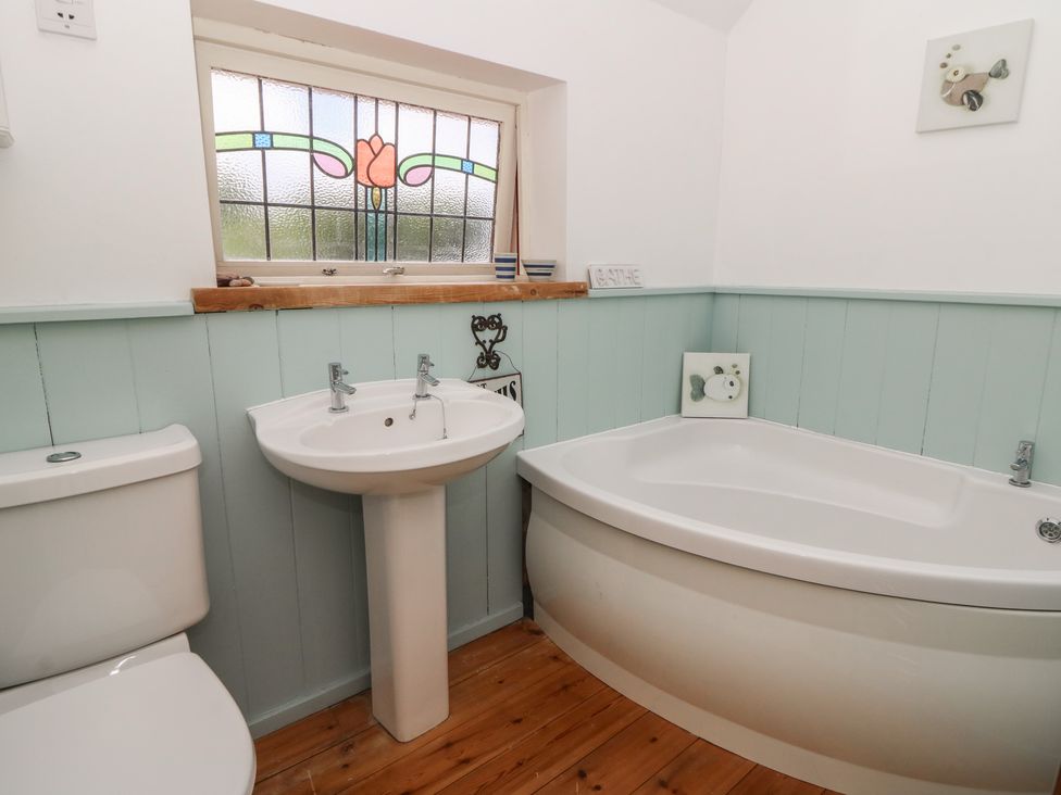 A bathroom with a bathtub and sink at St John's House in Newport, Pembrokeshire