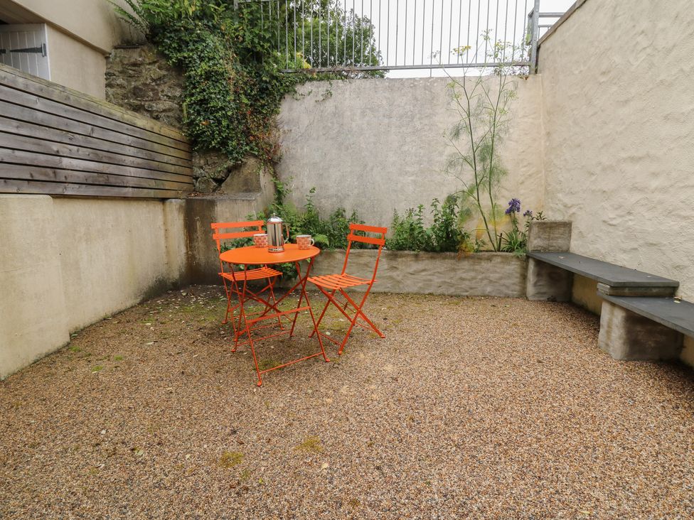 A gravel outdoor area with a table and chairs at St John's House in Newport, Pembrokeshire