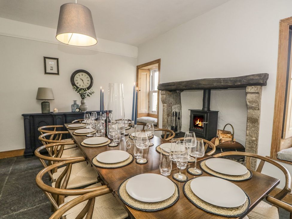 A dining room with a table set for a meal at Grove House in Grange-Over-Sands