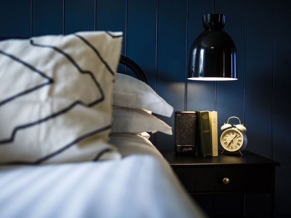 A bedroom with a bed and bedside table at Grove House in Grange-Over-Sands