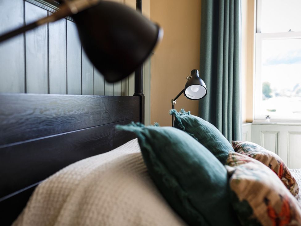 A bedroom with a bed and bedside lamps at Grove House in Grange-Over-Sands
