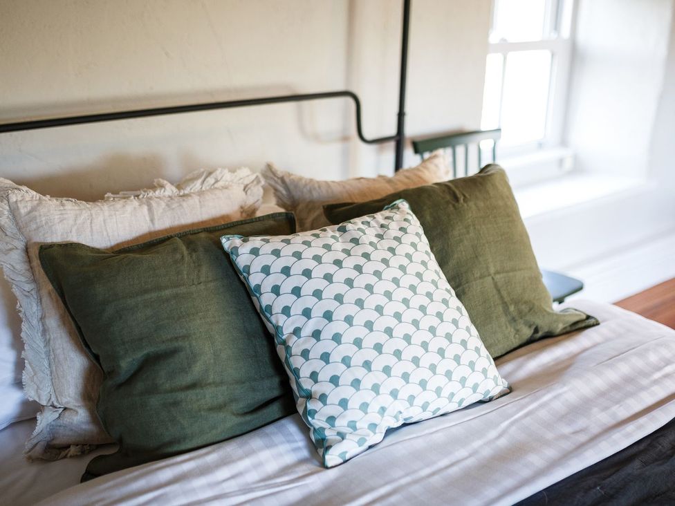 A bed with pillows in a bedroom at Grove House in Grange-Over-Sands