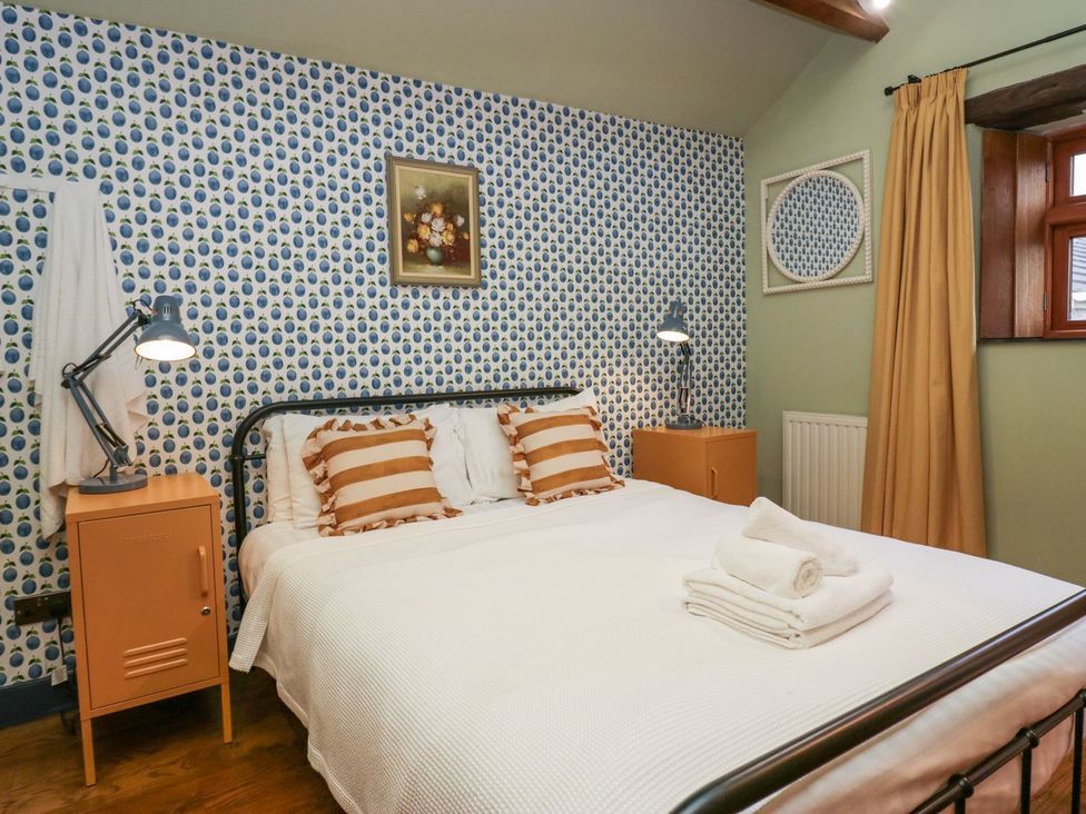 A bedroom with a bed and bedside table at Grove House in Grange-Over-Sands