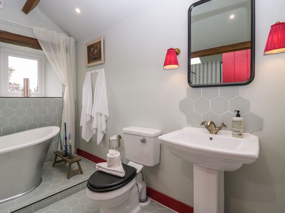 A bathroom with a bathtub and sink at Grove House in Grange-Over-Sands