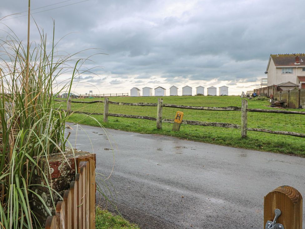 A view of a fence and sheds in a field at 3 Seaview Cottages Normans Bay near Bexhill-on-Sea