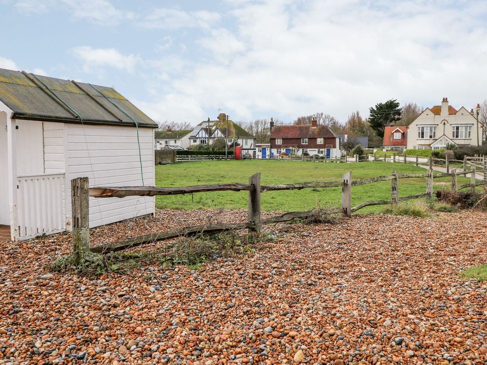 An outdoor area with a shed and fence at 3 Seaview Cottages in Normans Bay near Bexhill-on-Sea