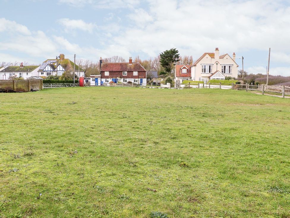 A view of houses and grassy area at 3 Seaview Cottages in Normans Bay near Bexhill-on-Sea