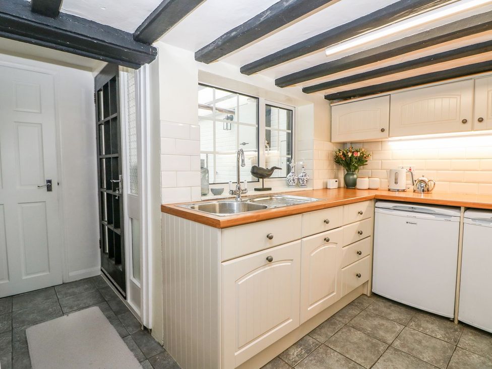 A kitchen with a sink and cabinets at 2 Seaview Cottages Normans Bay near Bexhill-On-Sea