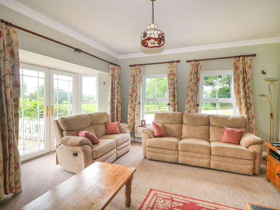 A living room with two sofas and a coffee table at The Lodge in Gorey, County Wexford